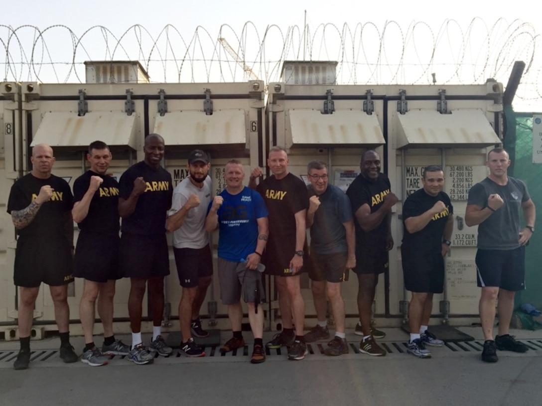 The group flexes its muscles after an intense, early morning workout led by Army Command Sgt. Maj. John Wayne Troxell, the senior enlisted advisor to the chairman of the Joint Chiefs of Staff, at Resolute Support headquarters in Kabul, Afghanistan, July 17, 2016. DoD photo by Lisa Ferdinando