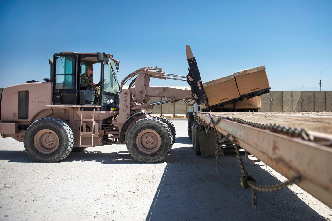 Air Force Airman 1st Class Hayden Kidder operates a forklift to move mail off a flatbed trailer at Bagram Airfield in Afghanistan, July 13, 2016. Kidder is a knowledge management journeyman assigned to the 455th Expeditionary Communications Squadron. Air Force photo by Senior Airman Justyn M. Freeman