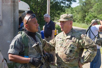 U.S. Army Brigadier Gen. Troy Kok, Deputy Commanding General Support, United States Army Recruiting Command, converses with Spc. Raymon Busto, 22nd Battalion, 22nd Infantry Regiment, 10th Mountain Division, during Warrior Exercise (WAREX) 86-16-03 at Fort McCoy, Wis., July 16, 2016. WAREX is designed to keep soldiers all across the United States ready to deploy. (U.S. Army photo by Spc. Cody Hein/Released)