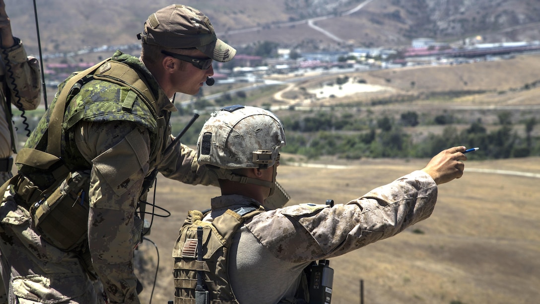 U.S. Marine Sgt. Joshua Dittman, a forward observer, points out a target to Canadian soldier Master Bombadier Sid Wiseman, a joint terminal attack controller, for a close air support mission during the Southern California portion of Rim of the Pacific 2016 training exercise at Marine Corps Base Camp Pendleton, California, July 13, 2016. The close air support missions help redefine and refine tactics in close air support and will also serve to assist the Mexican navy for laying the ground work and foundation for a structured tactical air control party school in the future. Units participating in the exercise were Marines with 1st Air Naval Gunfire Liaison Company, Canada’s 2e Battalion Royal 22e Régiment, and service members with the Mexican navy. Twenty-six nations, more than 40 ships and submarines, more than 200 aircraft and 25,000 personnel are participating in RIMPAC from June 30 to Aug. 4, in and around the Hawaiian Islands and Southern California. The world's largest international maritime exercise, RIMPAC provides a unique training opportunity that helps participants foster and sustain the cooperative relationships that are critical to ensuring the safety of sea lanes and security on the world's oceans. RIMPAC 2016 is the 25th exercise in the series that began in 1971.