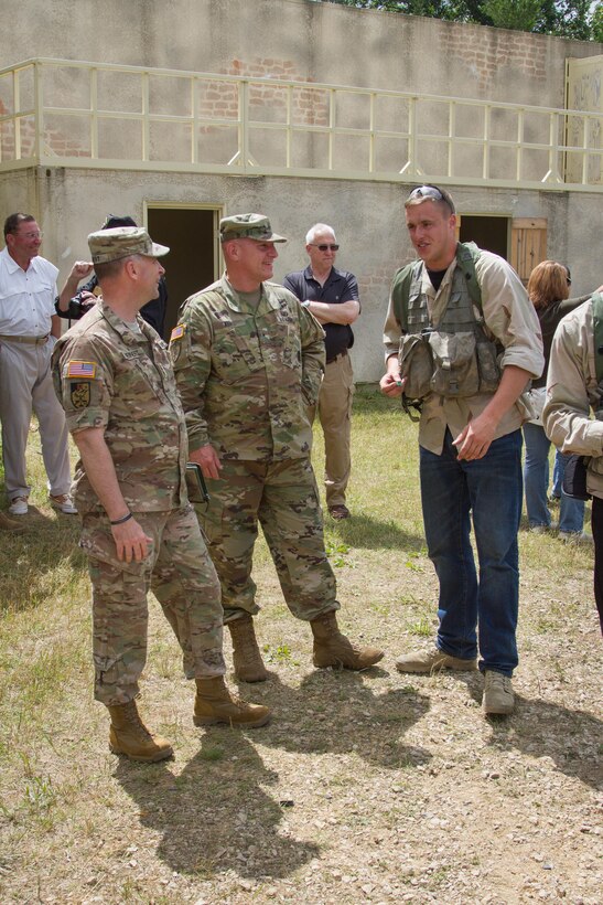 U.S. Army Major Gen. Patrick Reinert, Commanding General, 88th Regional Support Command, and Brigadier Gen. Troy Kok, Deputy Commanding General Support, United States Army Recruiting Command, converse with Pvt. Chad Turlington, 2nd Battalion, 22nd Infantry Regiment, 10th Mountain Division, during Warrior Exercise (WAREX) 86-16-03 at Fort McCoy, Wis., July 14, 2016. WAREX is designed to keep soldiers all across the United States ready to deploy. (U.S. Army photo by Spc. Cody Hein/Released)