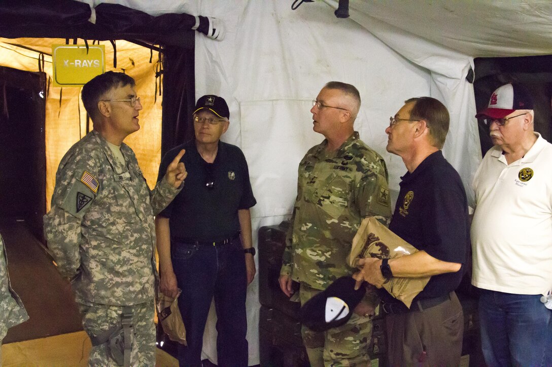 U.S. Army Lt. Colonel Peter Chase discusses his civilian and military career in emergency medicine with Major Gen. Michael Smith, Deputy Chief of Army Reserve and U.S. Army Reserve Ambassadors during Warrior Exercise (WAREX) 86-16-03 at Fort McCoy, Wis., July 16, 2016. WAREX is designed to keep soldiers all across the United States ready to deploy. (U.S. Army photo by Spc. Cody Hein/Released)