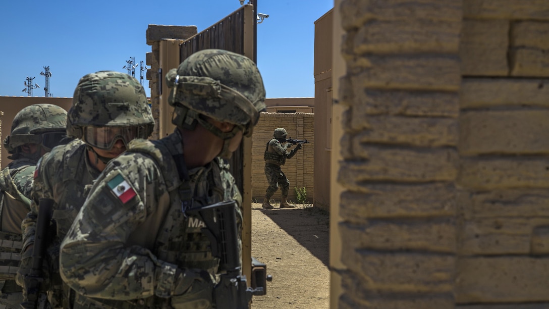Mexican sailors converge on a building while participating in a mechanized assault during the Southern California portion of Rim of the Pacific 2016, at Marine Corps Base Camp Pendleton, California, July 18, 2016. The purpose for the mechanized assault is so partner nations can integrate and communicate with each other for future operations. Units participating in the exercise were Marines with India Company, 3rd Battalion, 5th Marine Regiment and 3rd Assault Amphibious Battalion, both with the 1st Marine Division, and service members with the Mexican navy. Twenty-six nations, more than 40 ships and submarines, more than 200 aircraft and 25,000 personnel are participating in RIMPAC from June 30 to Aug. 4, in and around the Hawaiian Islands and Southern California. The world's largest international maritime exercise, RIMPAC provides a unique training opportunity that helps participants foster and sustain the cooperative relationships that are critical to ensuring the safety of sea lanes and security on the world's oceans. RIMPAC 2016 is the 25th exercise in the series that began in 1971.