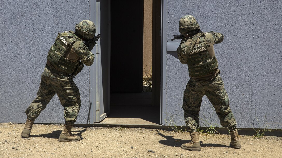 Mexican sailors clear a doorway while participating in a mechanized assault during the Southern California portion of Rim of the Pacific 2016 at Marine Corps Base Camp Pendleton, California, July 18, 2016. The purpose for the mechanized assault is so partner nations can integrate and communicate with each other for future operations. Units participating in the exercise were Marines with India Company, 3rd Battalion, 5th Marine Regiment and 3rd Assault Amphibious Battalion, both with the 1st Marine Division, and service members with the Mexican navy. Twenty-six nations, more than 40 ships and submarines, more than 200 aircraft and 25,000 personnel are participating in RIMPAC from June 30 to Aug. 4, in and around the Hawaiian Islands and Southern California. The world's largest international maritime exercise, RIMPAC provides a unique training opportunity that helps participants foster and sustain the cooperative relationships that are critical to ensuring the safety of sea lanes and security on the world's oceans. RIMPAC 2016 is the 25th exercise in the series that began in 1971.