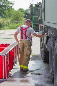 U.S. Army Cpl. Adam Harris from the 398th Engineer Detachment, Creston, Iowa, operates a M1158 HEMTT-based Water Tender during a firefighting training event during Warrior Exercise (WAREX) 86-16-03 at Fort McCoy, Wis., July 19, 2016. WAREX is designed to keep soldiers all across the United States ready to deploy. (U.S. Army photo by Spc. Cody Hein/Released)