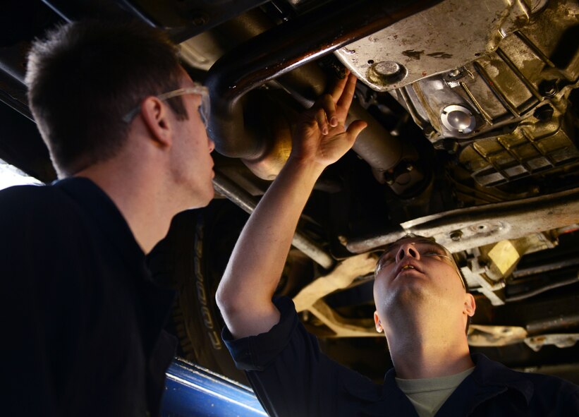 Senior Airman Zachary Caldwell and Airman 1st Class Gage Douglass, both 86th Vehicle Readiness Squadron vehicle maintainers, inspect the transmission of a pickup truck at Ramstein Air Base, Germany, July 13, 2016. The 86th VRS is responsible for keeping Ramstein’s government-owned vehicles in proper working condition. (U.S. Air Force photo/ Airman 1st Class Joshua Magbanua)