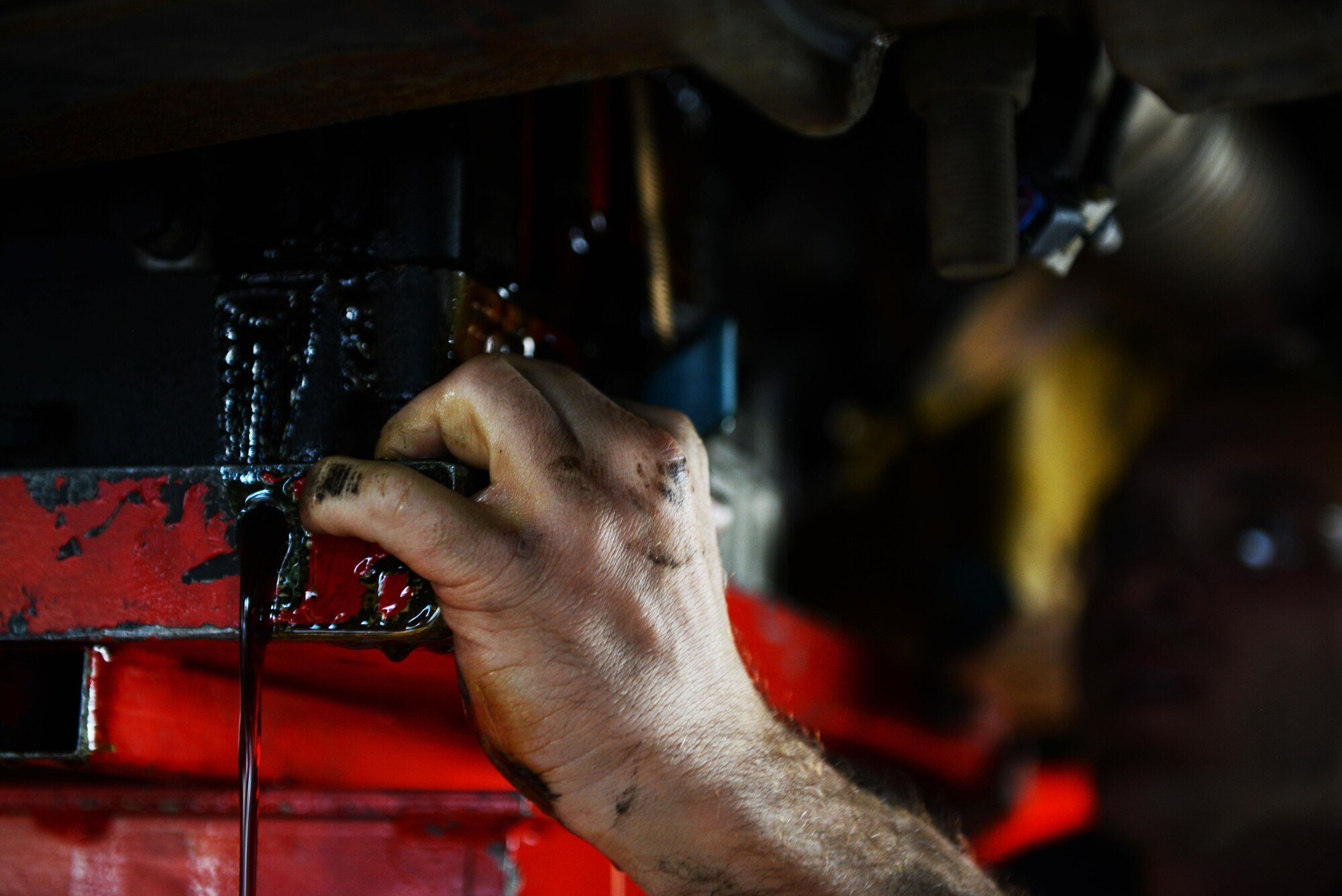 Fluid leaks out as 86th Vehicle Readiness Squadron vehicle maintainers prepare to remove a transmission from a bus at Ramstein Air Base, Germany, July 13, 2016. The 86th VRS services a wide variety of government-owned vehicles at Ramstein.  (U.S. Air Force photo/ Airman 1st Class Joshua Magbanua)