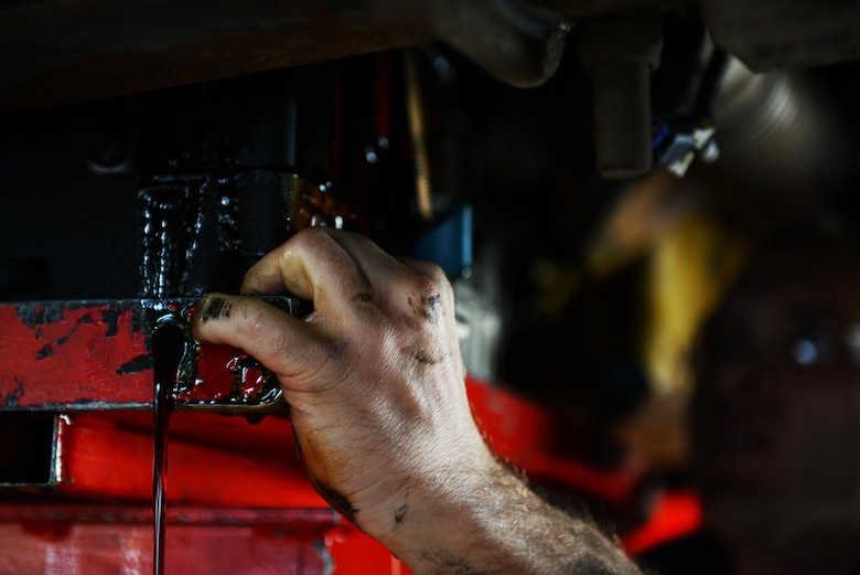 Fluid leaks out as 86th Vehicle Readiness Squadron vehicle maintainers prepare to remove a transmission from a bus at Ramstein Air Base, Germany, July 13, 2016. The 86th VRS services a wide variety of government-owned vehicles at Ramstein.  (U.S. Air Force photo/ Airman 1st Class Joshua Magbanua)