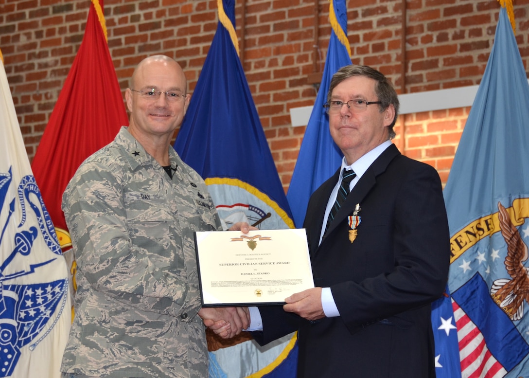 Defense Logistics Agency Aviation Commander Air Force Brig. Gen. Allan Day presents Daniel Stanko, supply systems analyst, DLA Aviation Business Process Support Directorate, with the Superior Civilian Service Award during his town hall held at the Lotts Center on Defense Supply Center Richmond, Virginia, July 15, 2016. 