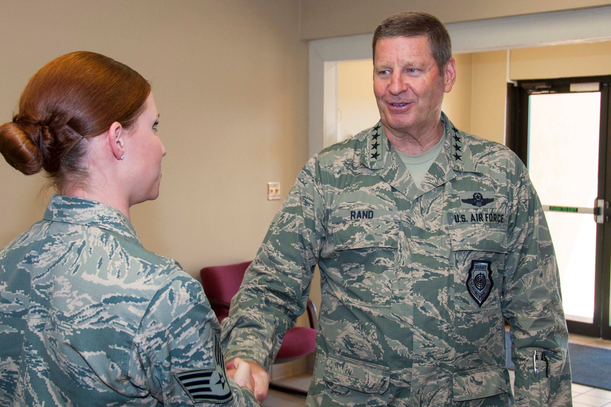 U.S. Air Force Gen. Robin Rand, Air Force Global Strike Command commander, presents a coin to Staff Sgt. Meagan Kay, 307th Operations Support Squadron aircrew flight equipment technician, at Barksdale Air Force Base, La., July 19, 2016.  Rand’s visit to the 307th OSS was part of a larger immersion tour designed to help him meet and understand the needs of Airmen carrying out the Air Force’s B-52 Stratofortress mission.  (U.S. Air Force photo by Tech. Sgt. Ted Daigle) 