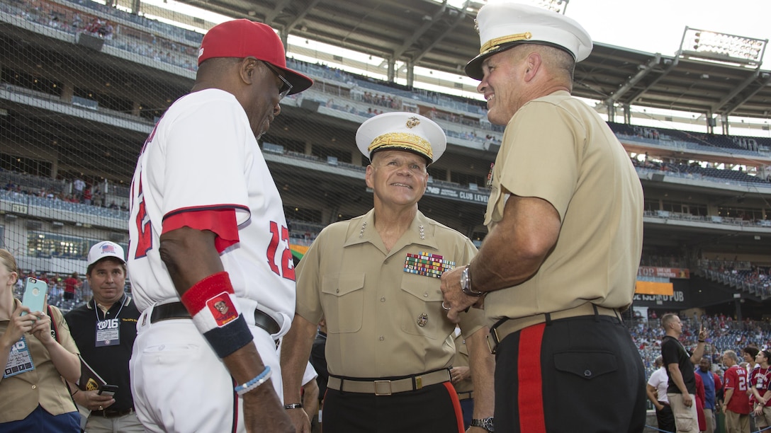 Commandant of the Marine Corps Gen. Robert B. Neller, center, speaks to Washington Nationals manager and fellow Marine veteran Dusty Baker, and Maj. Gen. John R. Ewers, before a baseball game at Nationals Park, Washington, D.C., July 20, 2016. Neller threw the ceremonial first pitch at the Washington National’s annual game honoring the Marine Corps.