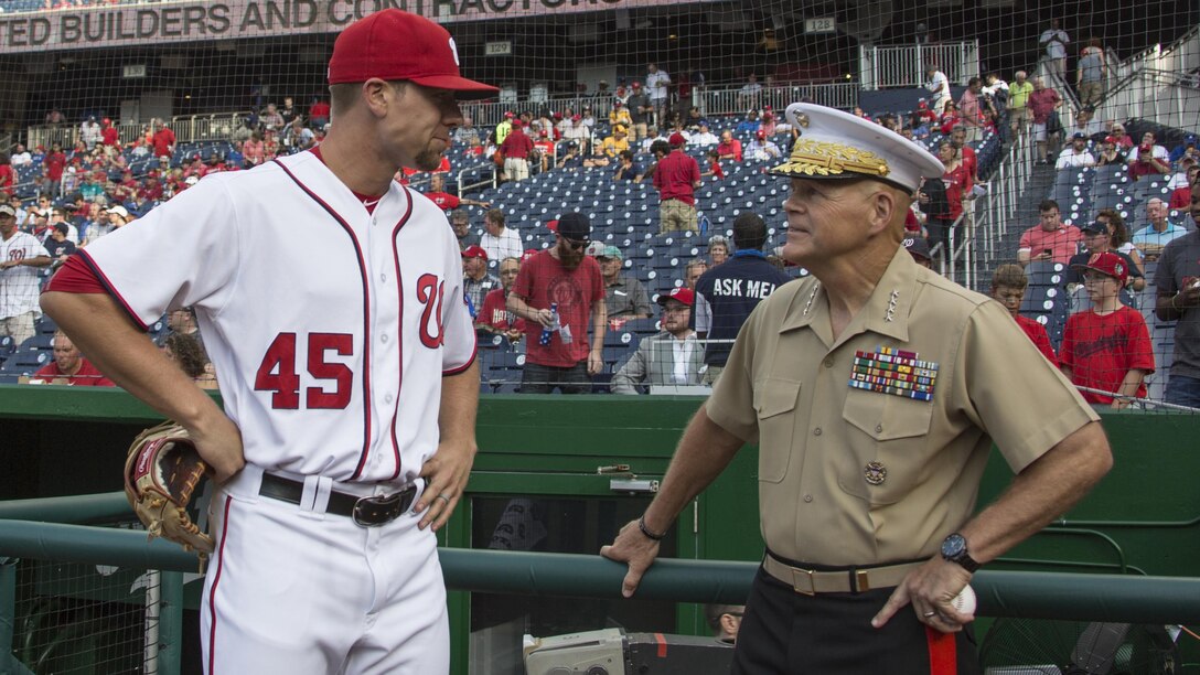 Commandant of the Marine Corps Gen. Robert B. Neller, right, speaks to Washington Nationals pitcher Blake Treinen prior to the start of a game at Nationals Park, Washington, D.C., July 20, 2016. Neller threw the ceremonial first pitch at the Washington National’s annual game honoring the Marine Corps.
