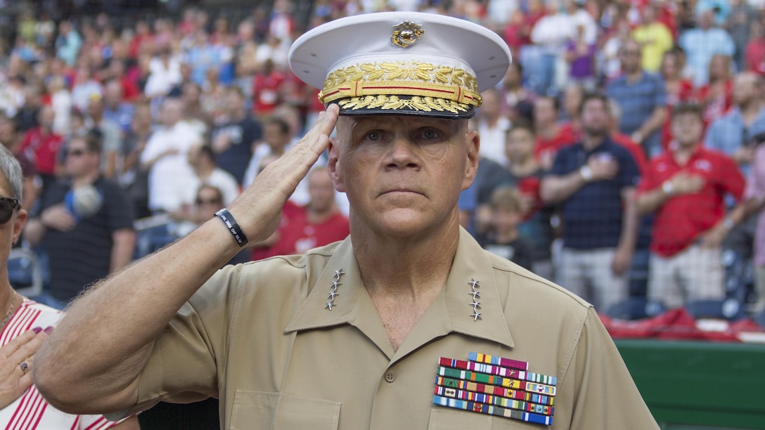 Commandant of the Marine Corps Gen. Robert B. Neller salutes during the National Anthem before a baseball game at Nationals Park, Washington, D.C., July 20, 2016. Neller threw the ceremonial first pitch at the Washington National’s annual game honoring the Marine Corps. 