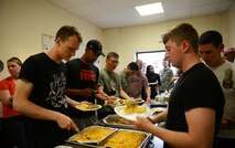 Airmen partake of a meal together at Ramstein Air Base, Germany, July 15, 2016. The free weekly dinner for Airmen E-4 and below is part of the ministry of Club 7. (U.S. Air Force photo/ Airman 1st Class Joshua Magbanua)