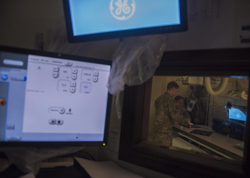 Staff Sgt. Keenan Dickens, diagnostic imaging technician, prepares a patient for a hand x-ray, Bagram Airfield, Afghanistan, July 20, 2016. X-ray imaging helps health care providers pin point injury origin and establish treatment for patients. (U.S. Air Force photo by Senior Airman Justyn M. Freeman)