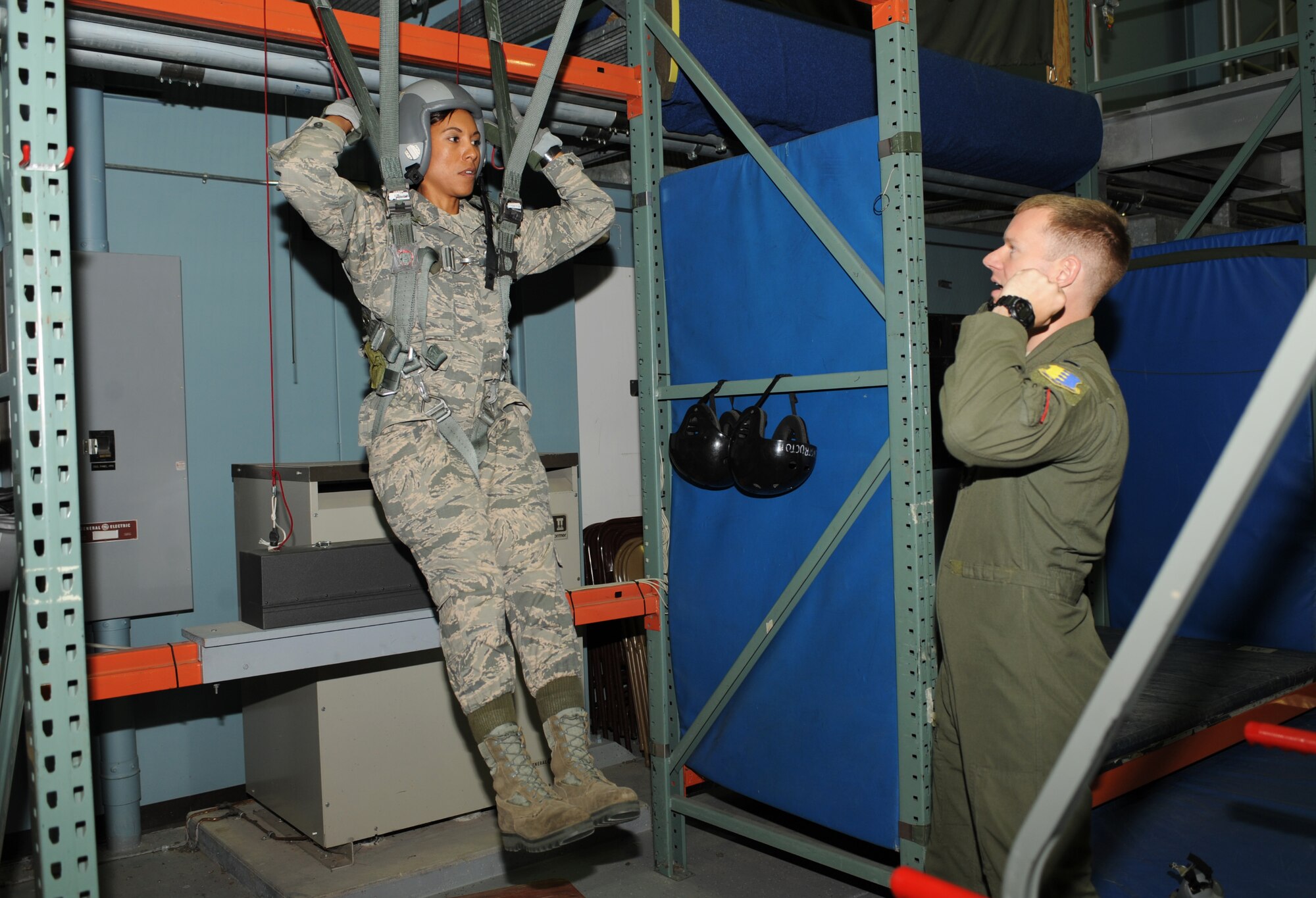 Chief Master Sgt. Sonia Lee, the command chief with the 28th Bomb Wing, practices different parachute steering methods as part of pre- flight training with 1st Lt. Matthew Herbstreth, 34th Bomb Squadron pilot, at Ellsworth Air Force Base, S.D., July 13, 2016. Lee learned how to identify different types of parachute malfunctions, how to fix them, and how to properly land after a fall. (U.S. Air Force photo by Airman 1st Class Denise M. Nevins)  