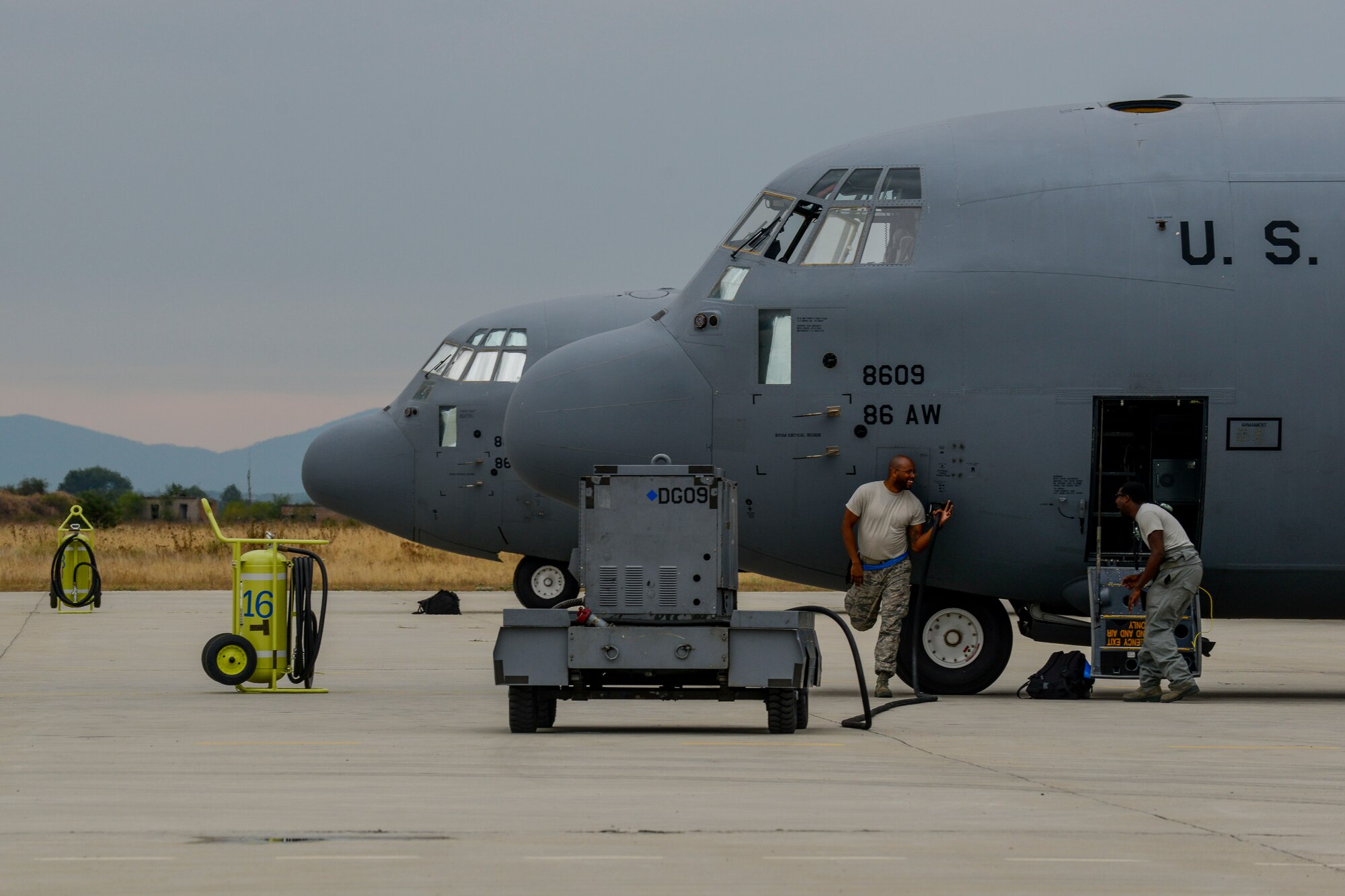 Airmen joke while inspecting a C-130J Super Hercules at Plovdiv Airport, Bulgaria July 20, 2016. Through Exercise Thracian Summer 2016, the United States and Bulgaria will enhance their mutual abilities to work together, with other NATO nations and with key regional partners on regional security, and help prepare Bulgaria for potential future operations in support of contingency operations around the world. The U.S. values the shared commitment and close cooperation with Bulgaria and other NATO allies on countering a range of regional and global threats. (U.S. Air Force photo/Senior Airman Nicole Keim)