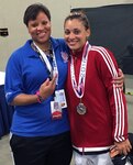 Spc. Nashayla Harper, a member of the New York Army National Guard's 42nd Combat Aviation Brigade, right, poses with her aunt and coach Mechelle Smith after winning the welter-weight class for 18 to 32-year old females at the 2016 Amateur Athletic Union (AAU) Taekwondo National Championships held in Fort Lauderdale, Florida, from July 4 to 9.