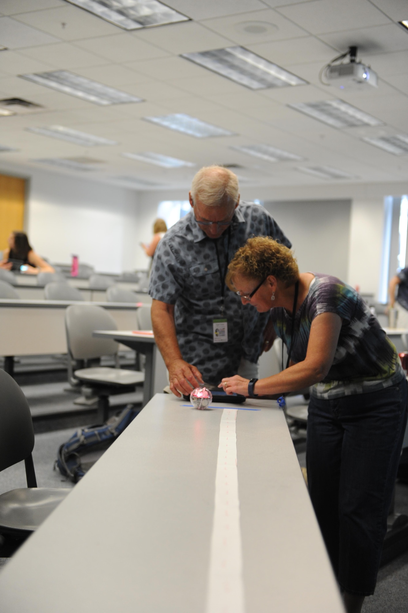 Teachers Roger Tucker from the Colorado Springs School and Deborah Andrews from Timberview Middle School, both of Colorado Springs, refine the robot’s initial programming for another run at bowling over an obstacle. The U.S. Air Force Academy hosted its annual STEM teacher boot camp July 19-21, bringing in 110 K-12 teachers from across Colorado and several other states, to improve STEM teaching skills. (U.S. Air Force photo by John VanWinkle)