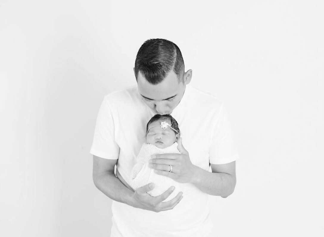 Army Sgt. Sean Holm, a chaplain’s assistant with the 17th Sustainment Brigade, holds his daughter, Adeline, born April 24, 2016. Courtesy photo