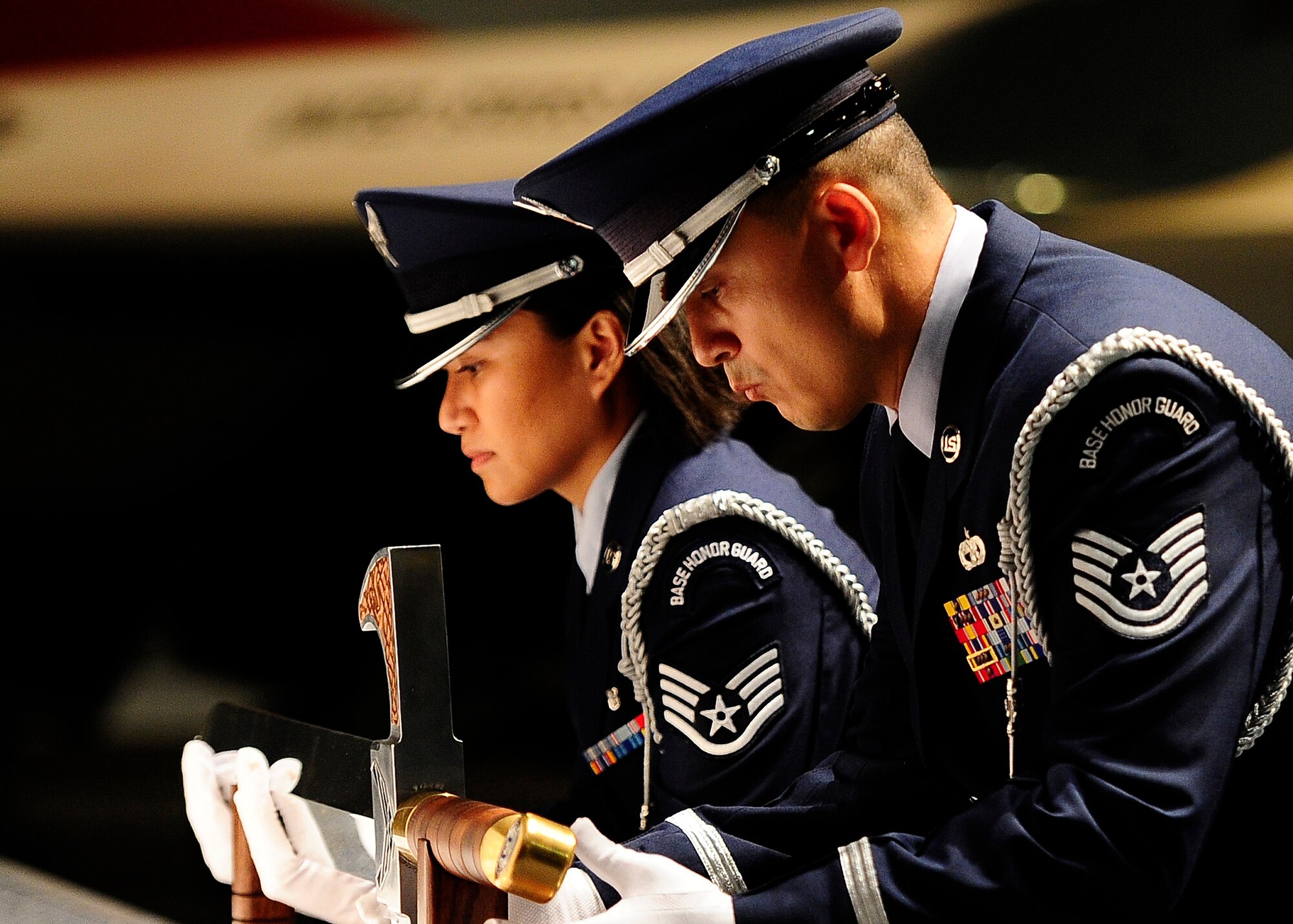 U.S. Air Force Honor Guard members Tech. Sgt. Juan Garcia and Staff Sgt. Annzen Salvador lift the sword used for the Order of the Sword ceremony at the Museum of Aviation in Warner Robins, Ga., July 13, 2016. The Order of the Sword is an honor awarded by the NCOs of a command to recognize individuals they hold in high esteem and for their contributions to the enlisted corps. (U.S. Air Force photo by Tech. Sgt. Stephen D. Schester)