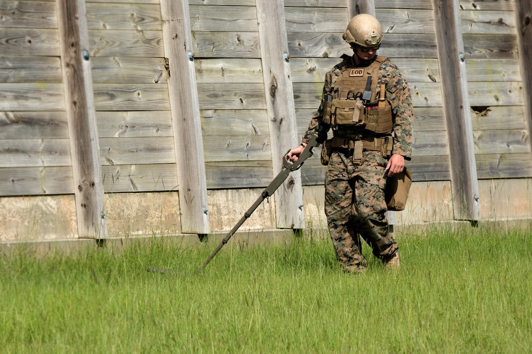 Sgt. David Jones, an explosive ordnance disposal team leader assigned to the 8th Engineer Support Battalion, scans for signs of an improvised explosive device during a training exercise at Camp Lejeune, N.C., July 19, 2016. The unit conducted the training to test the effects of different types of excavation charges. Marine Corps photo by Lance Cpl. Victoria Ross