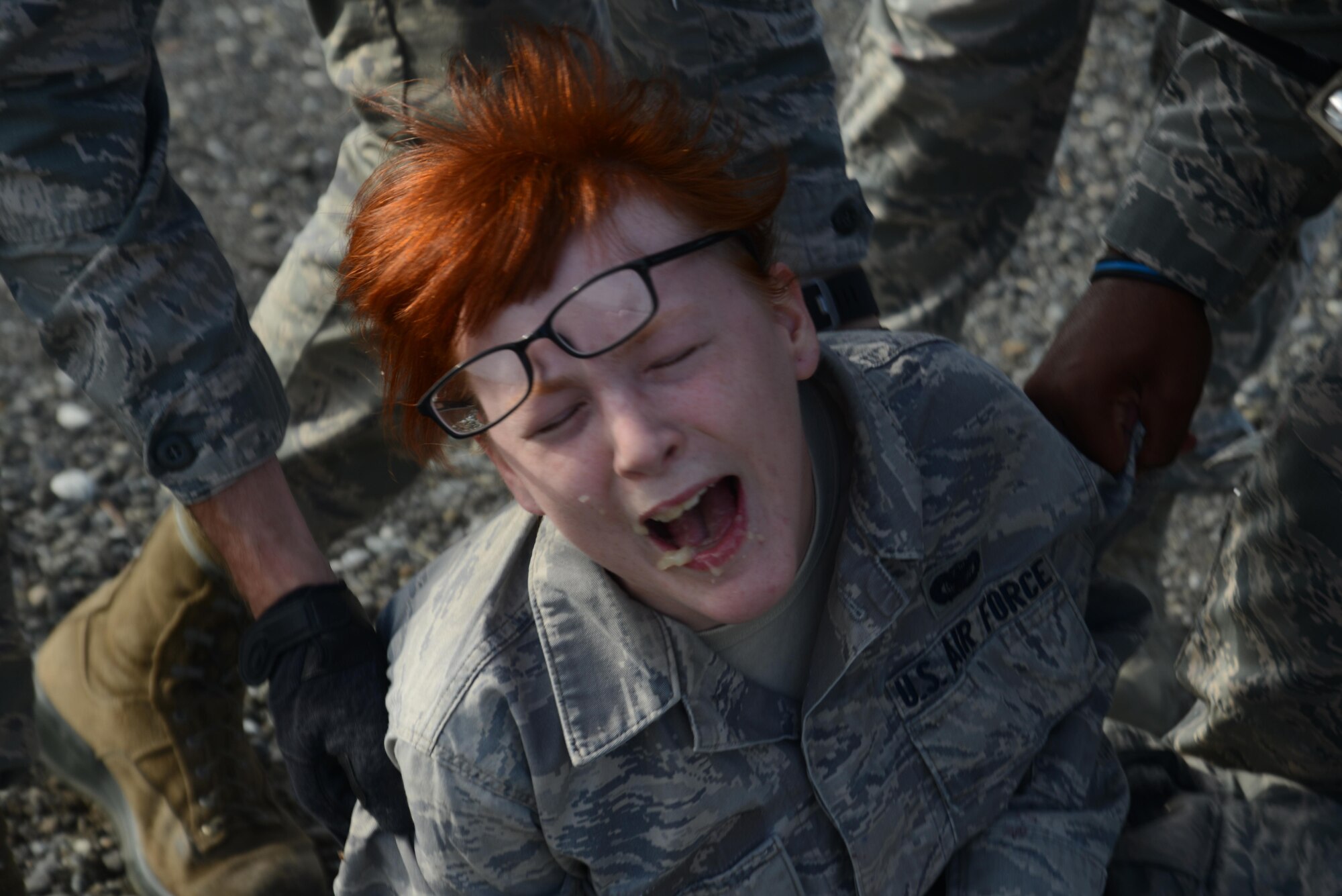 Senior Airman Katrina Kappele, 673d Contracting Squadron specialist, plays an explosion victim with a notional internal injury during Mission Assurance Exercise 16-7 at Joint Base Elmendorf-Richardson, Alaska, July 15, 2016. JBER simulated an aircraft crash to test the base’s ability to operate, coordinate and recover in an efficient and timely manner. (U.S. Air Force photo by Airman 1st Class Christopher R. Morales)