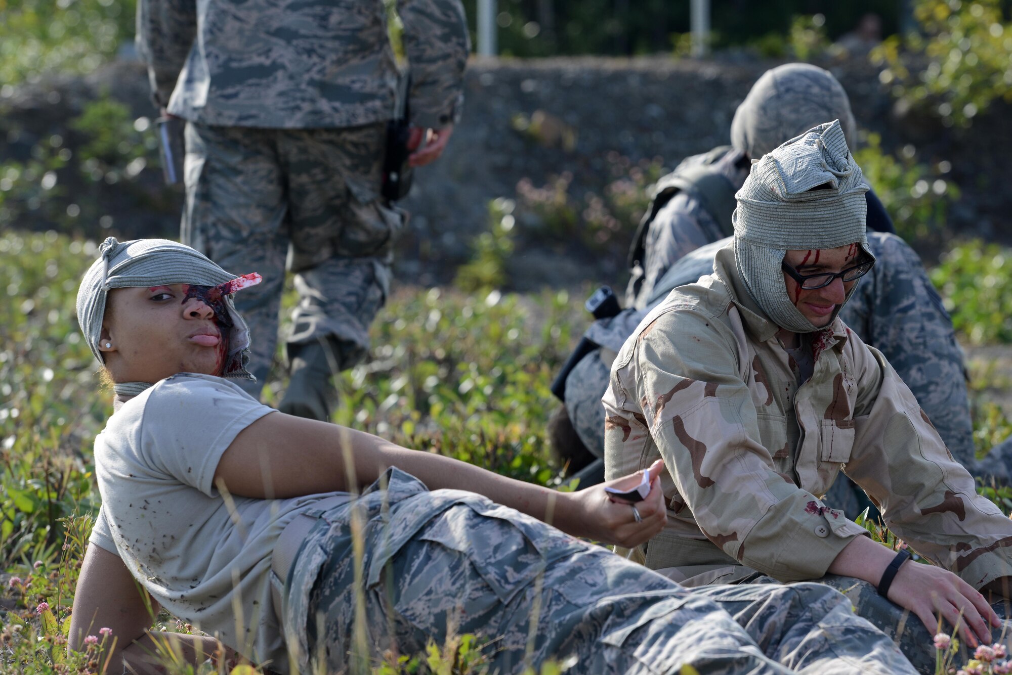 Airman 1st Class Bianka Best, 3rd Maintenance Group maintenance analyst, awaits further medical care for her moulaged eye injury during Mission Assurance Exercise 16-7 at Joint Base Elmendorf-Richardson, Alaska, July 15, 2016. JBER simulated crash to test the base’s ability to operate, coordinate and recover in an efficient and timely manner. (U.S. Air Force photo by Airman 1st Class Christopher R. Morales)