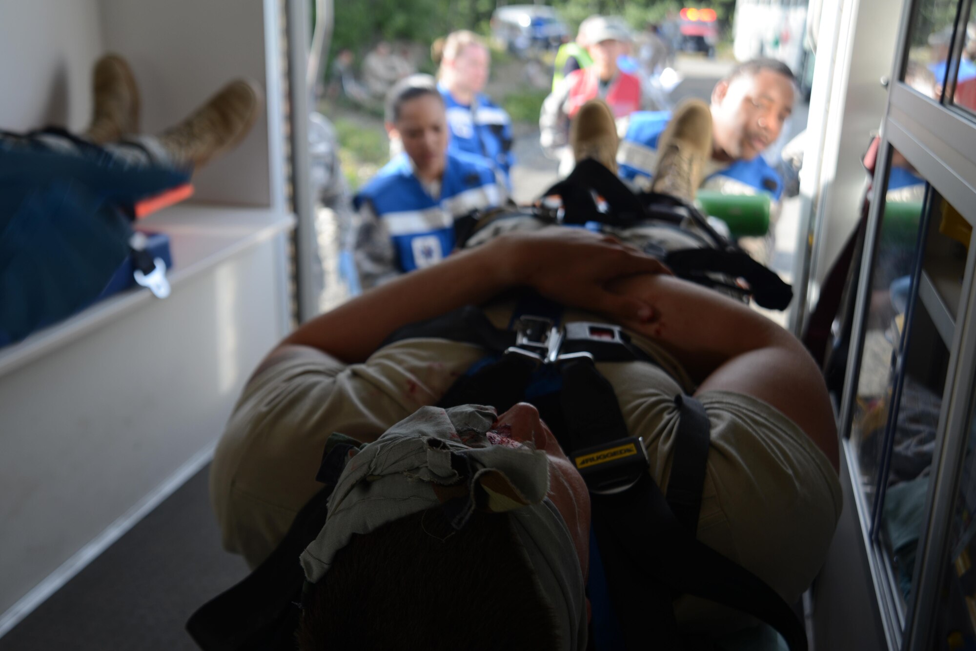 The Joint Base Elmendorf-Richardson hospital first responders put a simulated crash victim into an ambulance during Mission Assurance Exercise 16-7 at Joint Base Elmendorf-Richardson, Alaska, July 15, 2016. JBER simulated an aircraft crash to test the base’s ability to operate, coordinate and recover in an efficient and timely manner. (U.S. Air Force photo by Airman 1st Class Christopher R. Morales)
