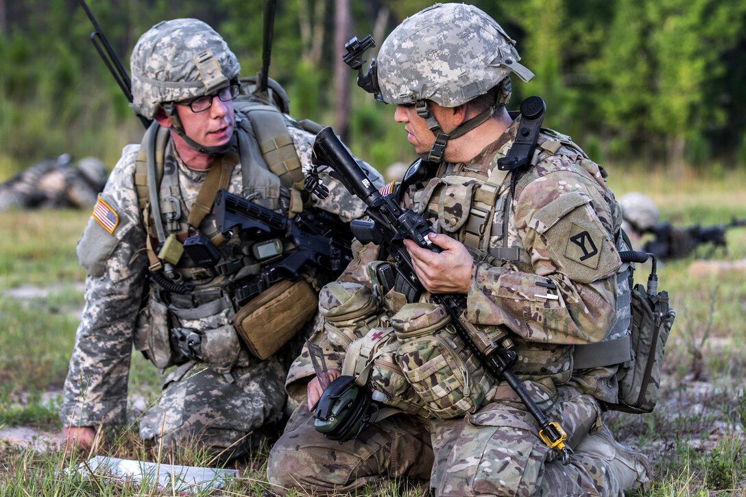 Army Staff Sgt. Alex Vath, right, and 1st Lt. Daniel Leclair discuss mission tactics during a combined arms live-fire exercise at Peason Ridge, La., July 15, 2016. Vath and Leclair are assigned to the Massachusetts Army National Guard’s Company C, 1st Battalion, 182nd Infantry Brigade. Army National Guard photo by Sgt. Michael Davis