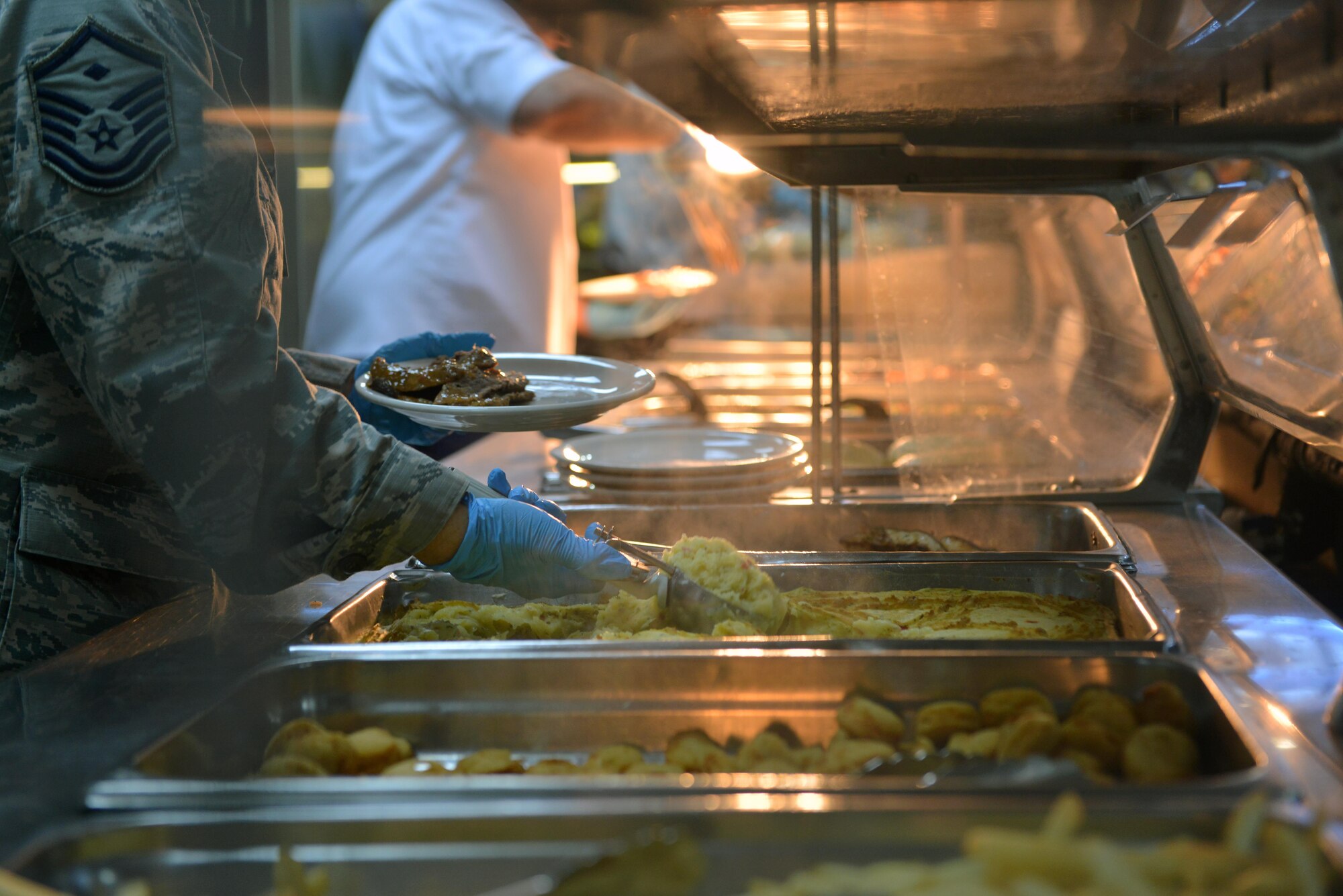 U.S. Air Force Master Sgt. Michele Mathews, 39th Force Support Squadron and Contracting Squadron first sergeant, serves food for patrons in the Sultan’s Inn Dining Facility July 21, 2016, at Incirlik Air Base, Turkey. Patrons were served a variety of food to include chicken breasts, potatoes and pot roast. (U.S. Air Force photo by Senior Airman John Nieves Camacho)