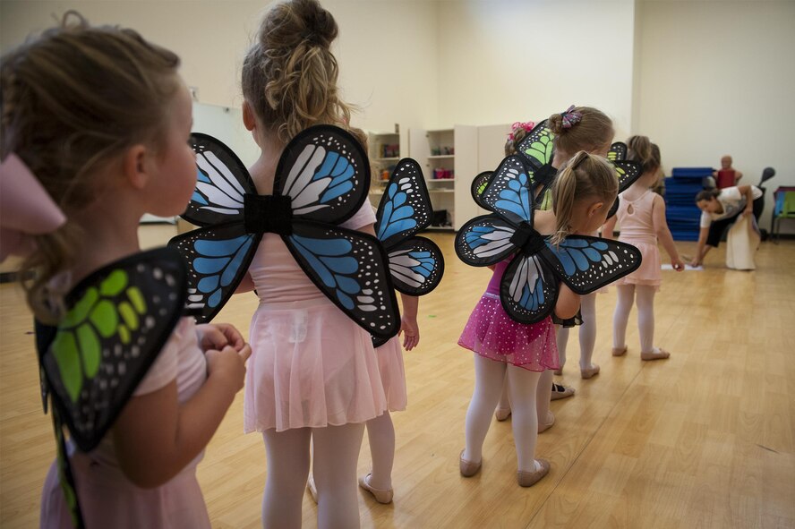 Dancers wait in line for instructions during a youth dance camp, July 19, 2016, at Moody Air Force Base, Ga. During the activity, dancers portrayed butterflies flying over a puddle of water, allowing them to learn how to jeté. (U.S. Air Force photo by Airman 1st Class Lauren M. Hunter)