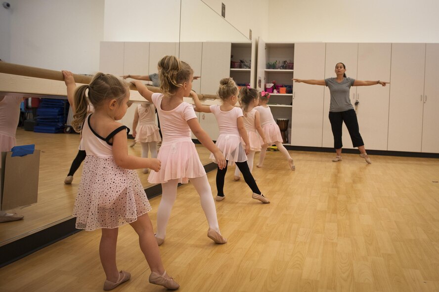 Tara Burgess, dance instructor, teaches children how to balance during a youth dance camp, July 20, 2016, at Moody Air Force Base, Ga. The youth center hosted the dance classes to keep children active during the summer while also teaching them discipline and social skills. (U.S. Air Force photo by Airman 1st Class Lauren M. Hunter)