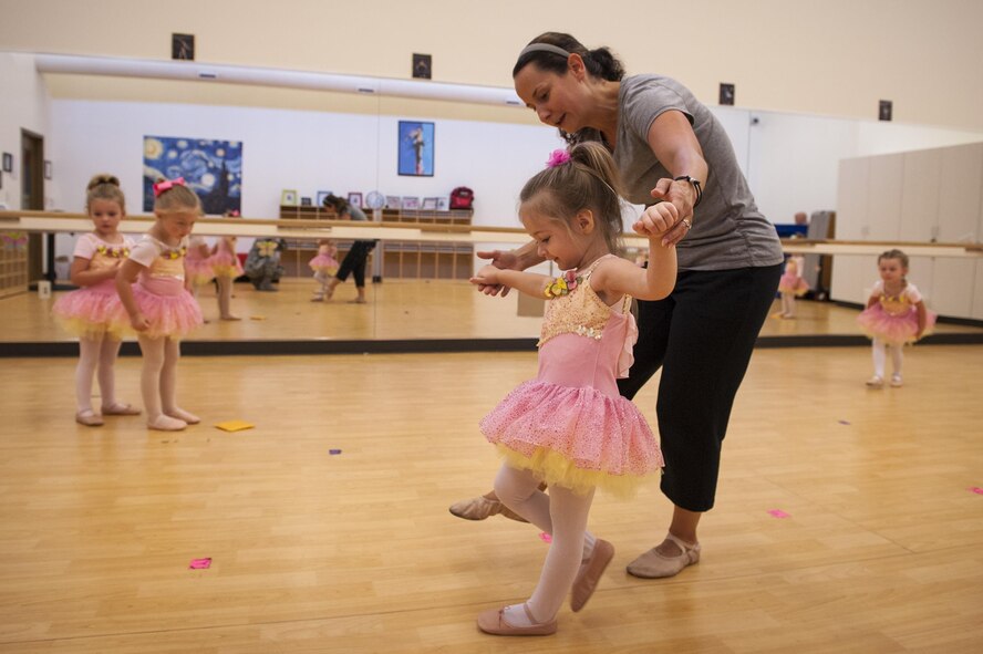 Tara Burgess, dance instructor, teaches Margot, daughter of U.S. Air Force Staff Sgt. Jesse Larue, 23d Equipment Maintenance Squadron munitions inspector, to point her toes during a youth dance camp, July 20, 2016, at Moody Air Force Base, Ga. Children learned various ballet moves each day in preparation for a performance on the last day of the week-long camp. (U.S. Air Force photo by Airman 1st Class Lauren M. Hunter)