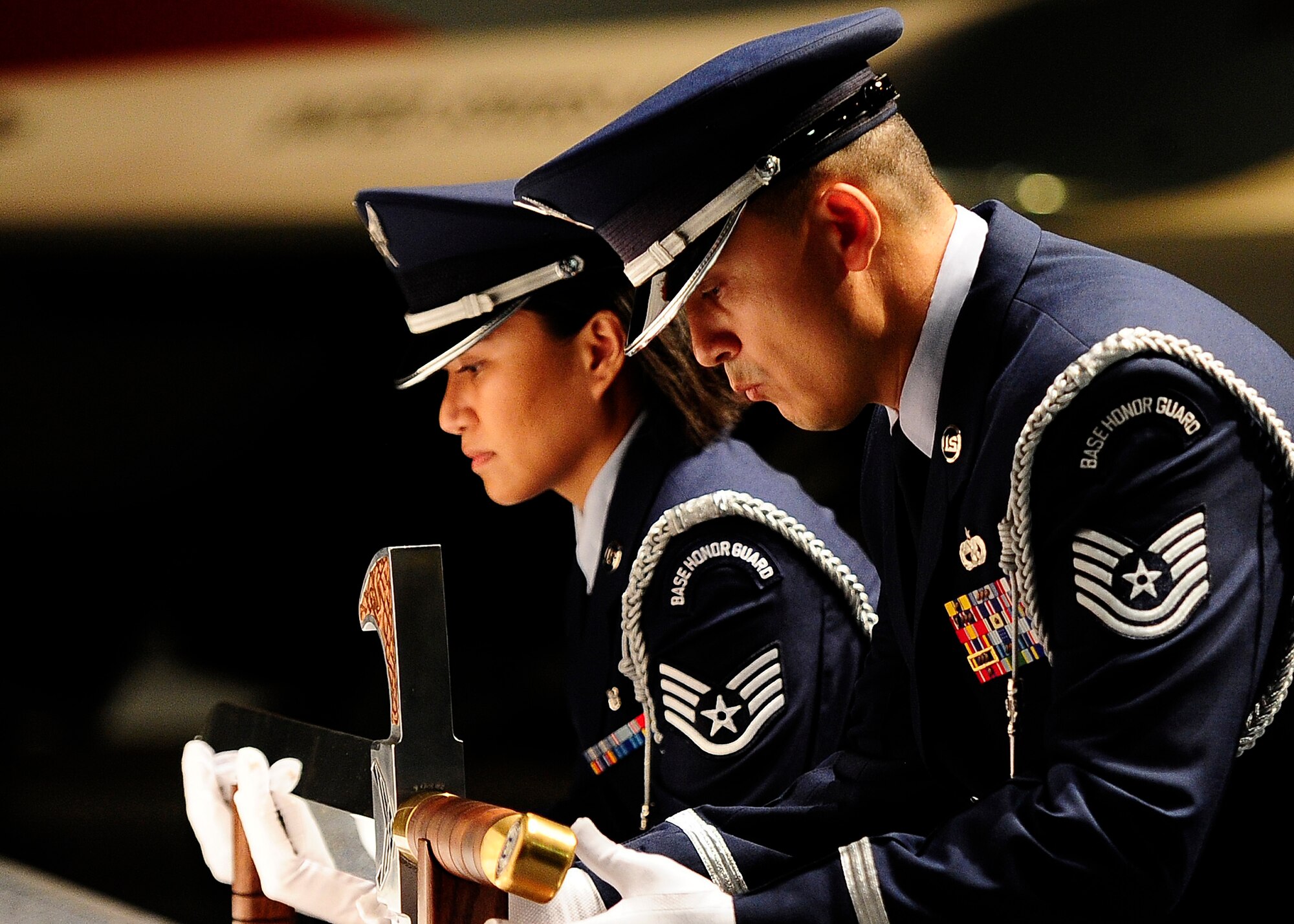 U.S. Air Force Honor Guard members Tech. Sgt. Juan Garcia and Staff Sgt. Annzen Salvador lift the sword used for the Order of the Sword ceremony at the Museum of Aviation in Warner Robins, Ga., July 13, 2016. The Order of the Sword is an honor awarded by NCOs of a command to recognize individuals they hold in high esteem and for their contributions to the enlisted corps. (U.S. Air Force photo/Tech. Sgt. Stephen D. Schester)                      