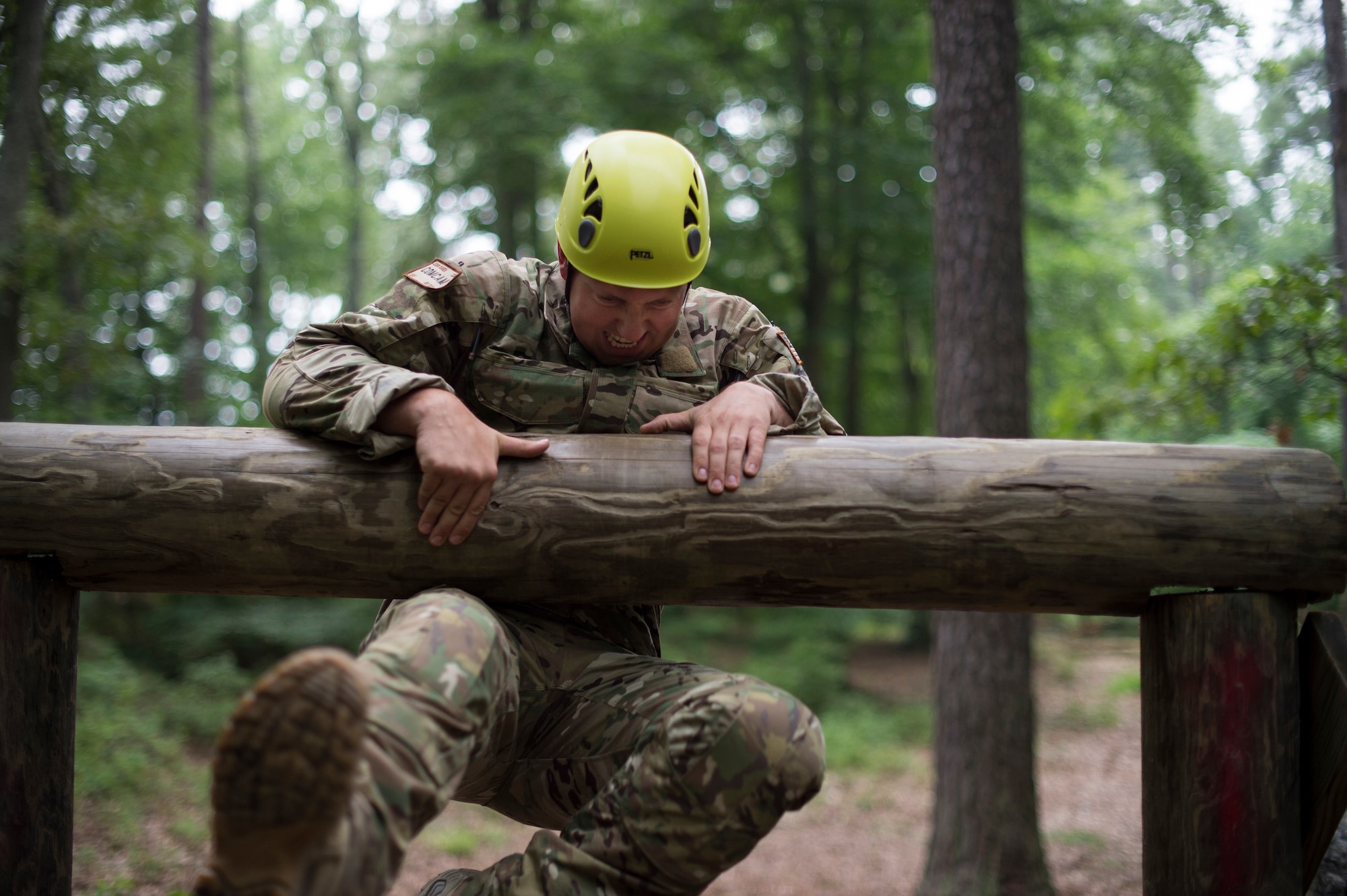 Staff Sgt. John Raven, a 1st Combat Camera aerial combat videographer, attempts to pull himself over an obstacle during the Spc. Hilda I. Clayton Best Combat Camera Competition (BCCC) at Fort A.P. Hill, Va., July 13, 2016. This is the fourth annual iteration of BCCC, which brings together combat camera service members throughout the Defense Department to compete in a series of events to showcase each unit’s abilities. (U.S. Air Force photo/Airman 1st Class Justin Parsons)                                                                                       