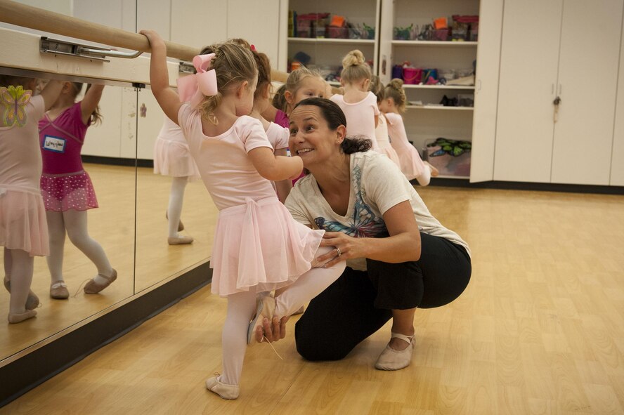 Tara Burgess, dance instructor, teaches Abigail, daughter of U.S. Air Force Staff Sgt. Greg Dorton, 41st Rescue Squadron special missions aviator, how to perform a piqué during a youth dance camp, July 19, 2016, at Moody Air Force Base, Ga. Each day throughout the week, dancers learned at least one new ballet move including: relevé, piqué, chassé, plié, sautteé and jeté. (U.S. Air Force photo by Airman 1st Class Lauren M. Hunter)