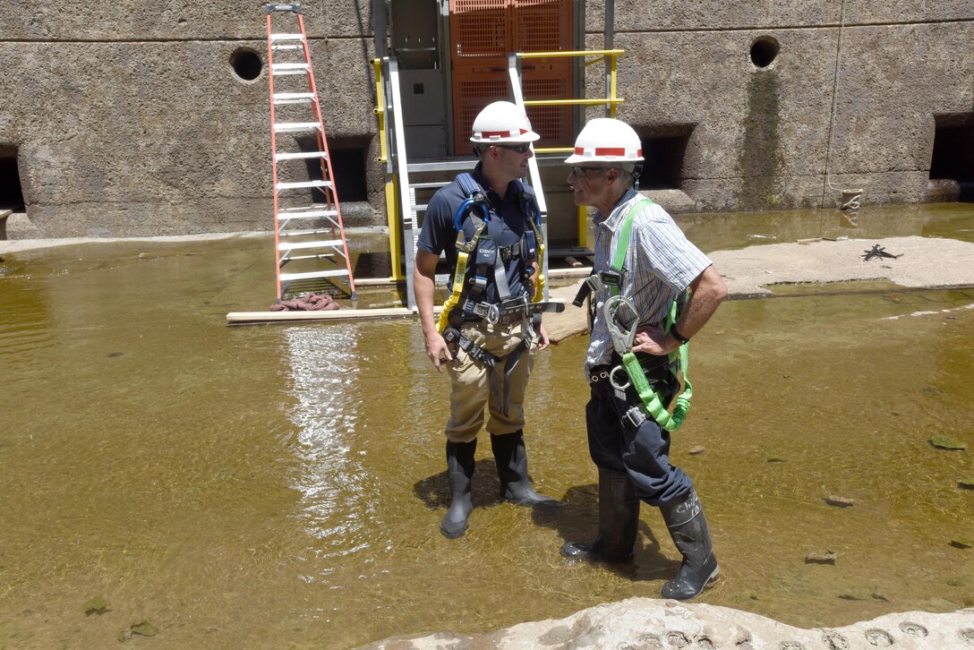 Tom Hale (Right), Tennessee River Operations manager, and Mason Carter, civil engineer in the Nashville District Navigation Branch, inspect the ongoing maintenance work July 20, 2016 at Chickamauga Lock on the Tennessee River in Chattanooga, Tenn.  The U.S. Army Corps of Engineers dewatered the lock to inspect and repair the miter gates and other underwater components from July 11 to Aug. 11.