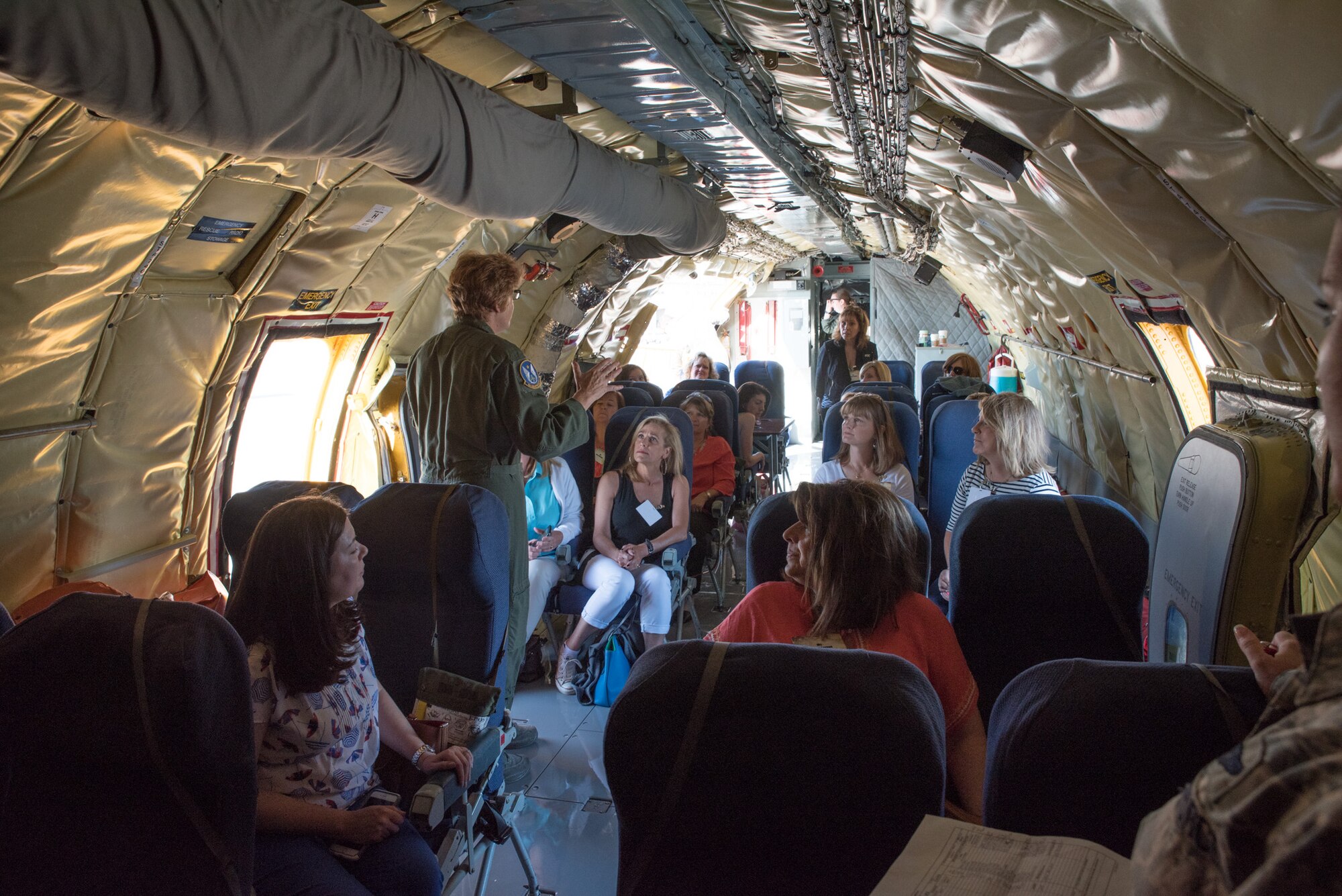 U.S. Air Force Chief Master Sgt. Kathleen Lowman, boom operator from the 18th Air Refueling Squadron, McConnell Air Force Base, Kan., briefs military spouses prior to take-off inside a KC-135 Stratotanker at Robins Air Force Base Georgia,  July 14, 2016. The spouses received the orientation flight during the Air Force Reserve Command commander's conference at Robins AFB.  (U.S. Air Force photo by Master Sgt. Eric J. Amidon)