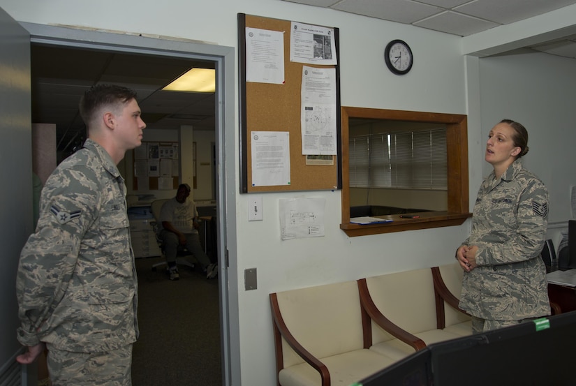 Tech. Sgt. Quinn White, 11th Logistics Readiness Squadron NCO in charge of vehicle operations, answers questions from Airman 1st Class Samuel Lingle, 11th LRS vehicle operator, at Joint Base Andrews, Md., July 13, 2016. White spent four years as a military training leader for students attending the Defense Information School at Ft. Meade, Md., prior to being stationed at JBA. (U.S. Air Force photo by Rustie Kramer) 