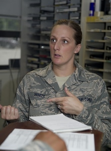 Tech. Sgt. Quinn White, 11th Logistics Readiness Squadron NCO in charge of vehicle operations, talks with Tech. Sgt. Louis Myers, 11th LRS chief dispatcher, about an Airman at Joint Base Andrews, Md., July 13, 2016. White spent four years as a military training leader for students attending the Defense Information School at Ft. Meade, Md., prior to be stationed at JBA. (U.S. Air Force photo by Rustie Kramer)