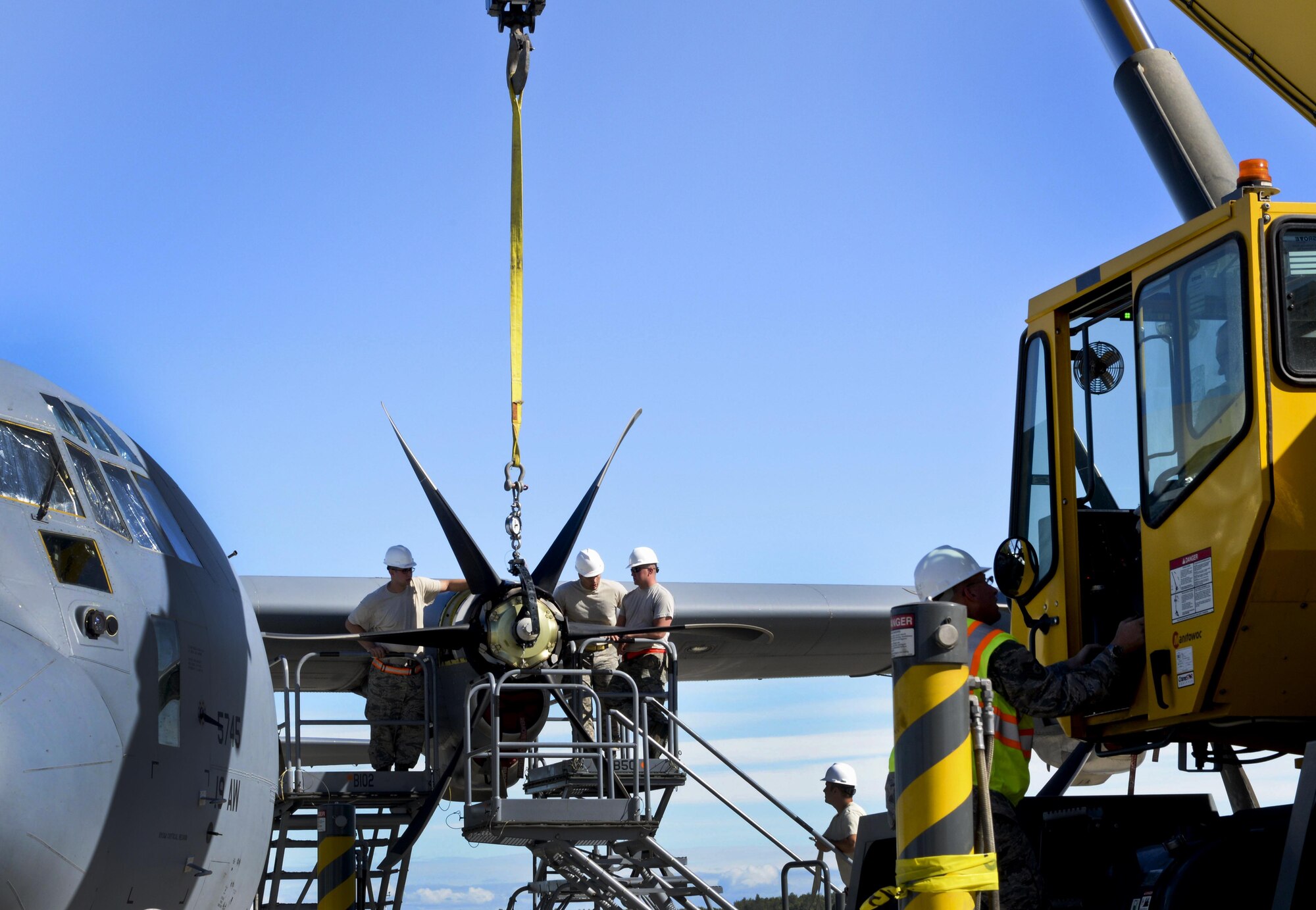 U.S. Air Force personnel from the 19th Aircraft Maintenance Squadron remove a damaged propeller on a C-130J July 21, 2016, at Joint Base Elmendorf-Richardson, Alaska. Replacing a propeller can take approximately five hours. The 19th AMXS participated in Exercise Artic Anvil where 41st Airlift Squadron C-130J aircrews conducted training in mountainous terrain. Aircraft maintenance is crucial in ensuring C-130Js are safe and certified to conduct missions.  (U.S. Air Force photo by Senior Airman Stephanie Serrano)