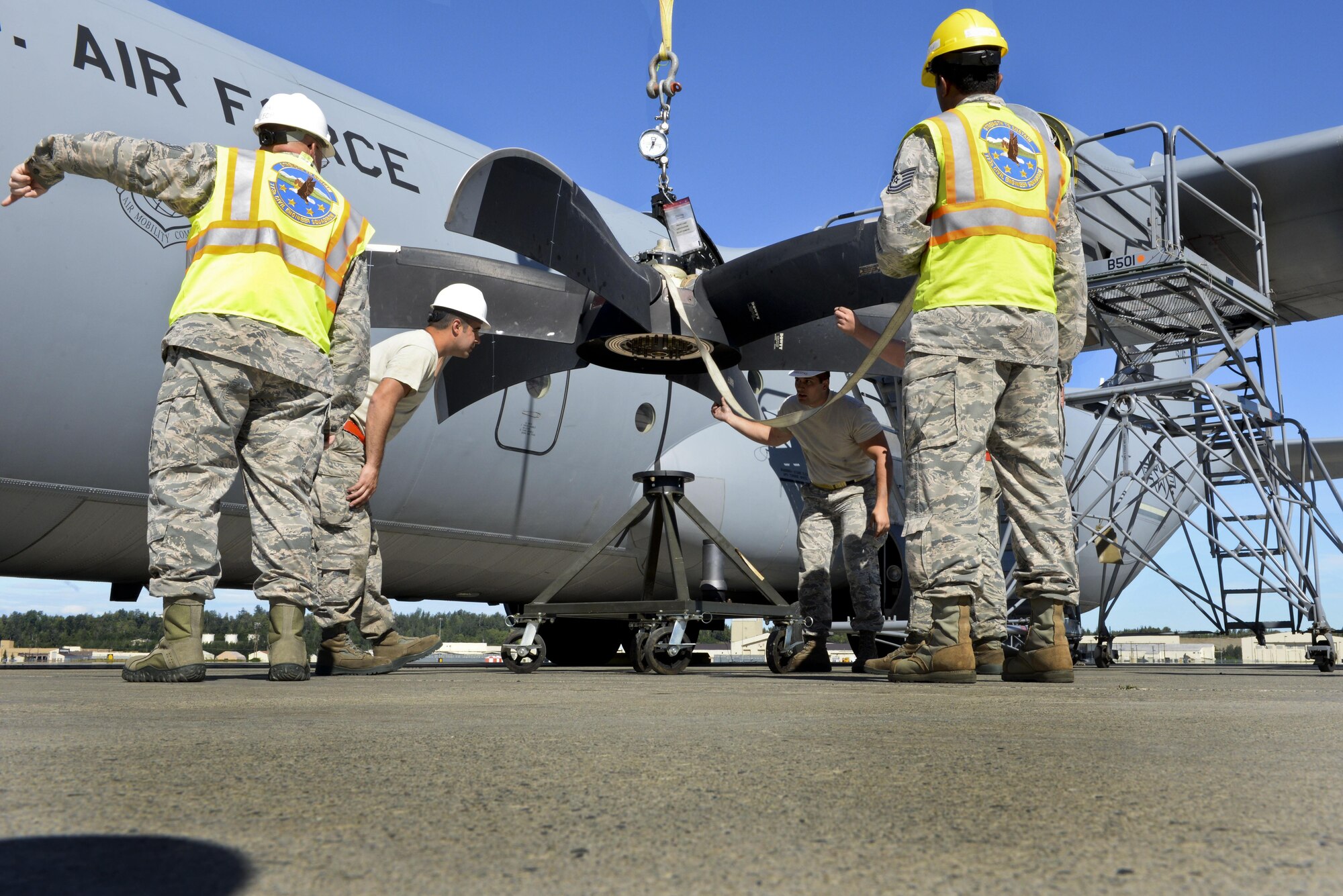 U.S. Air Force personnel secure a damaged C-130J propeller July 21, 2016, at Joint Base Elmendorf-Richardson, Alaska. The de-ice boot on the propeller failed an inspection, making it unusable. The 19th AMXS supported Exercise Artic Anvil where 41st Airlift Squadron aircrews conducted training to ensure combat airlift can be executed in a multitude of environments. (U.S. Air Force photo by Senior Airman Stephanie Serrano)