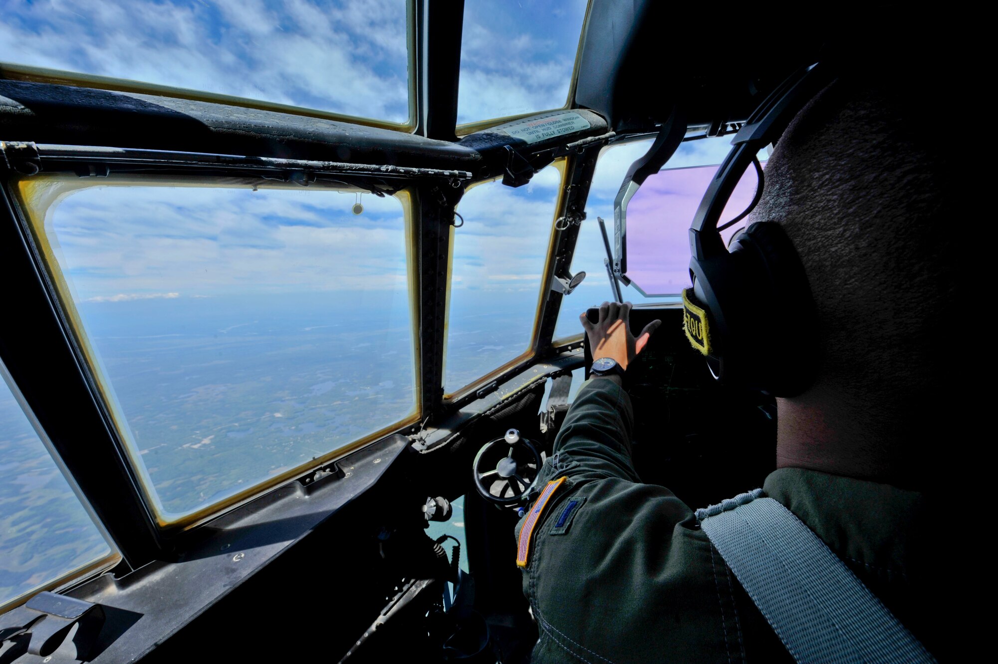 U.S. Air Force 1st Lt. Joshua Travis, 41st Airlift Squadron C-130J pilot, flies a C-130J July 17, 2016, over Alaska. C-130J aircrews from the 41st AS routinely travel across the world to ensure combat airlift can be executed globally in a moment’s notice. (U.S. Air Force photo by Senior Airman Stephanie Serrano)