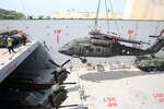 A UH-60 helicopter is lowered into general purpose, heavy lift ship MV OCEAN GLORY during a backload of equipment at Chuk Samet, here, from exercise Hanuman Guardian, July 12. Military Sealift Command’s contracted voyage-charter MV OCEAN GLORY recently conducted a backload of about 250 items in Thailand as part of U.S. Army Pacific’s mobility operation PACIFIC PATHWAYS 16-2. 