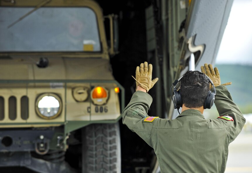 U.S. Air Force personnel work alongside U.S. Army personnel to load a Humvee into the back hull of a C-130J from the 41st Airlift Squadron from Little Rock Air Force Base, Ark., July 19, 2016, at Ladd Army Airfield, Alaska, in support of exercise Arctic Anvil. Arctic Anvil is an integrated combined, joint and coalition training event integrating the U.S Air Force, U.S. Army Alaska, Alaska National Guard, Iowa National Guard, 196th Infantry Brigade and the Canadian military. (U.S. Air Force photo by Senior Airman Stephanie Serrano)
