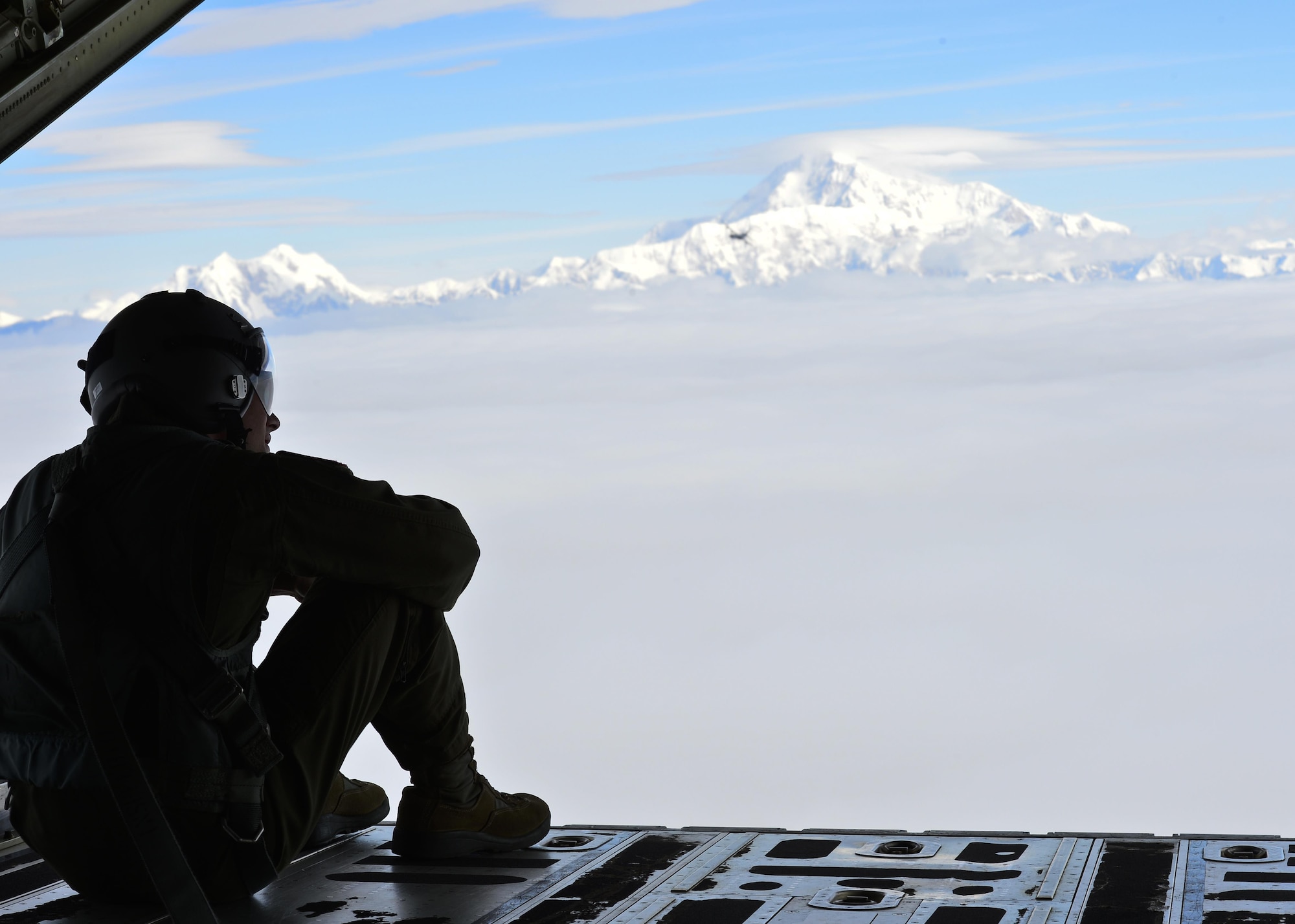 U.S. Air Force Senior Airman Jordon Speedy, 41st Airlift Squadron loadmaster, overlooks the Alaskan landscape July 19, 2016. The 41st AS is conducting training in Alaska to prepare for the terrain present in austere locations. Alaska provides an uncontended airspace which allows aircrews to train more effectively without having to adjust to commercial flight patterns. (U.S. Air Force photo by Senior Airman Kaylee Clark)