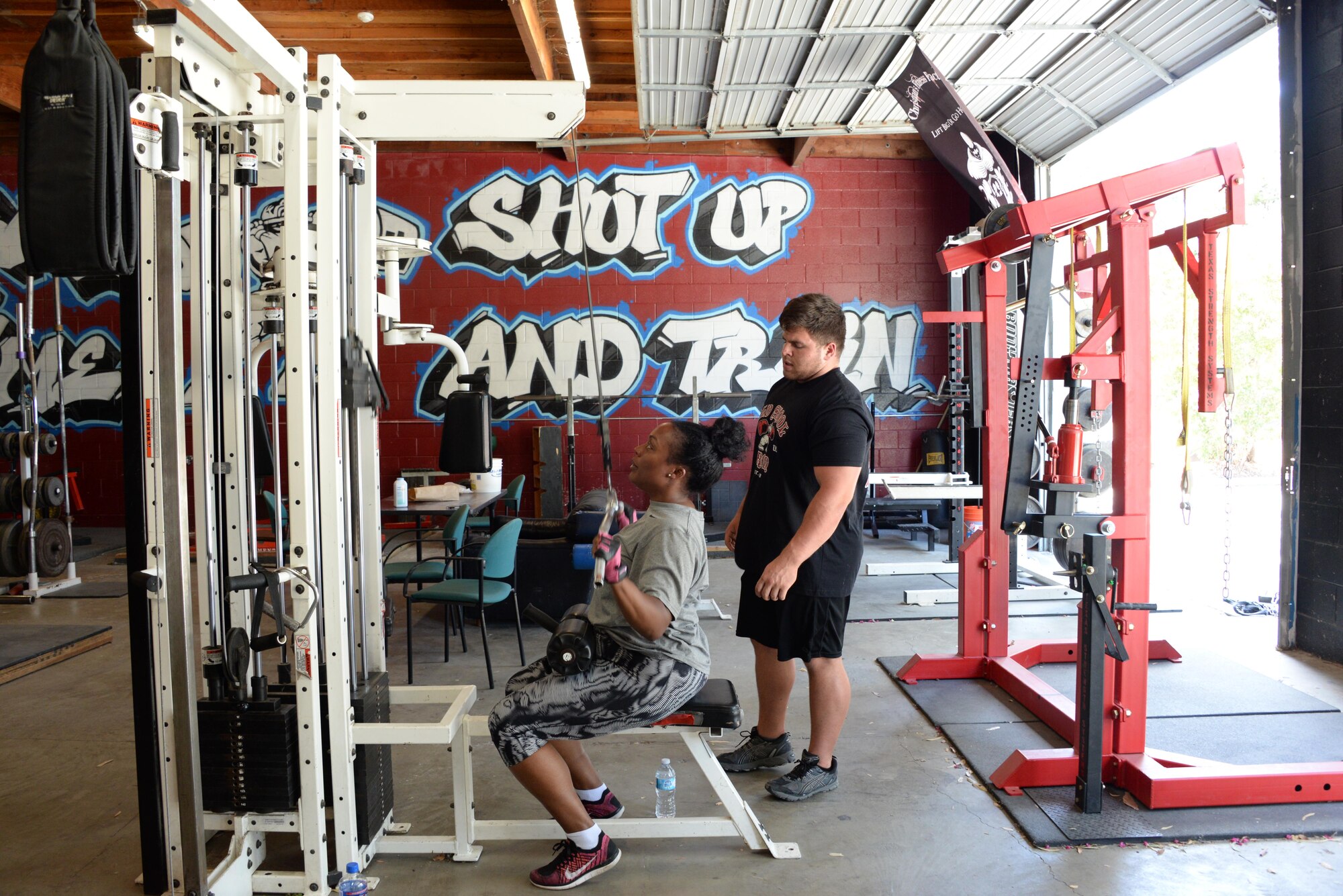 Staff Sgt. Tamika Hamilton, 60th Logistics Readiness Squadron customer service support, works July 8 with her off-base trainer, Kevin Pulsipher. Hamilton changed her workout routine after giving birth in October 2015. 
