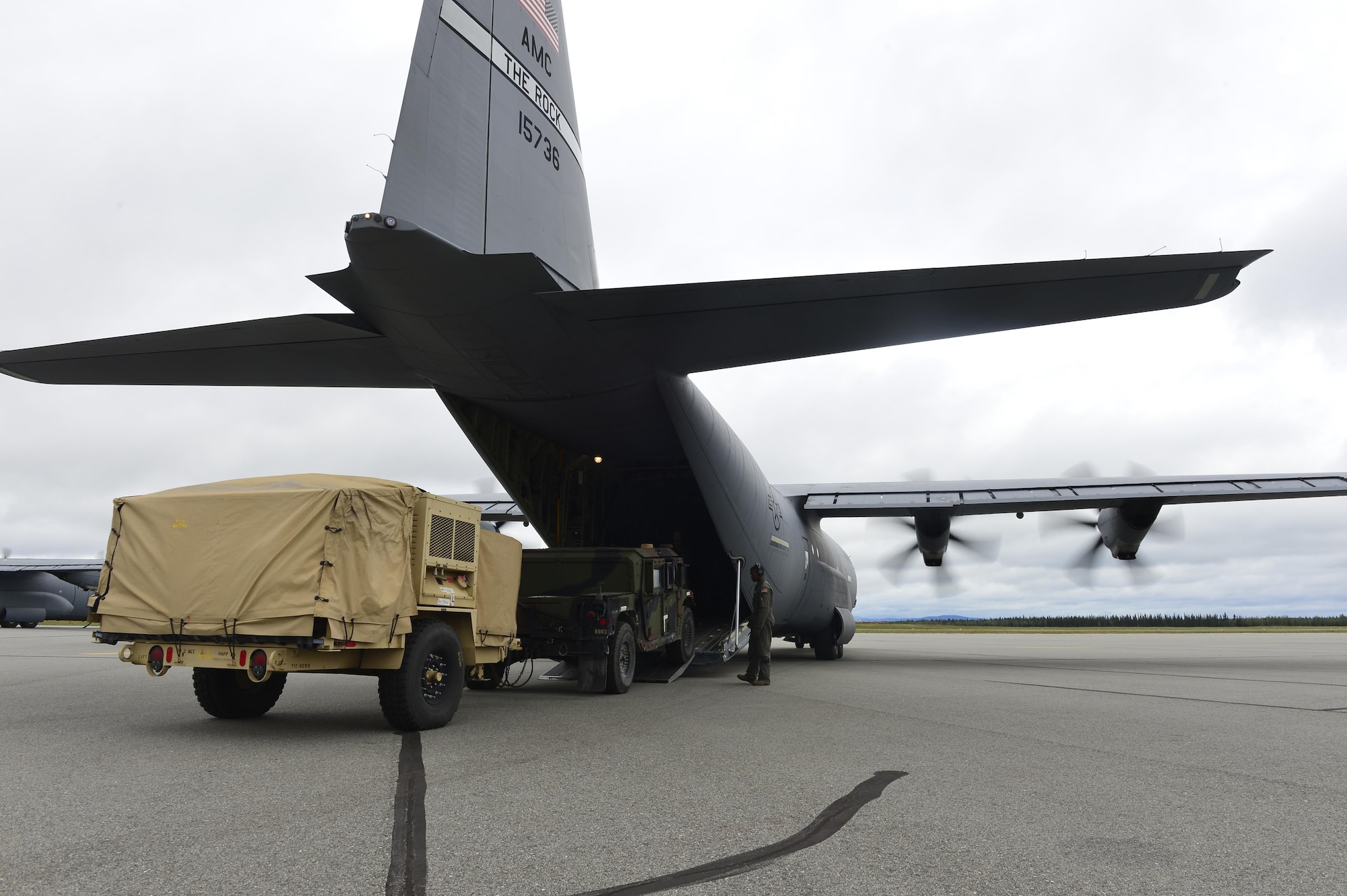 U.S. Air Force personnel work alongside U.S. Army personnel to load a Humvee into the back hull of a C-130J from the 41st Airlift Squadron from Little Rock Air Force Base, Ark., July 19, 2016, at Ladd Army Airfield, Alaska, in support of exercise Arctic Anvil. Arctic Anvil is an integrated combined, joint and coalition training event integrating the U.S Air Force, U.S. Army Alaska, Alaska National Guard, Iowa National Guard, 196th Infantry Brigade and the Canadian military. (U.S. Air Force photo by Senior Airman Kaylee Clark)