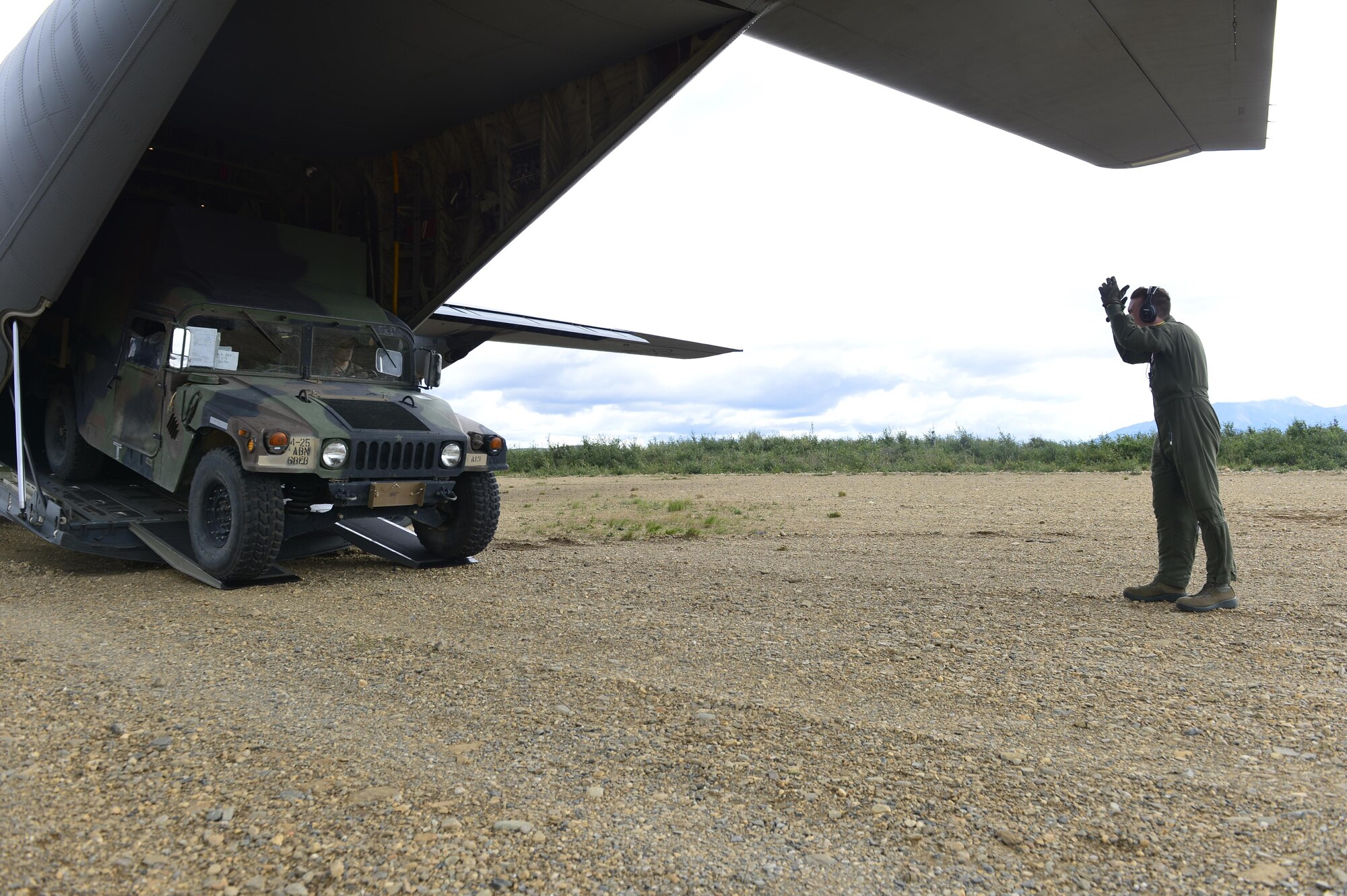 U.S. Air Force personnel work alongside U.S. Army personnel to offload a Humvee into the back hull of a C-130J from the 41st Airlift Squadron from Little Rock Air Force Base, Ark., July 19, 2016, at Ladd Army Airfield, Alaska, in support of exercise Arctic Anvil. Arctic Anvil is an integrated combined, joint and coalition training event integrating the U.S Air Force, U.S. Army Alaska, Alaska National Guard, Iowa National Guard, 196th Infantry Brigade and the Canadian military. (U.S. Air Force photo by Senior Airman Kaylee Clark)